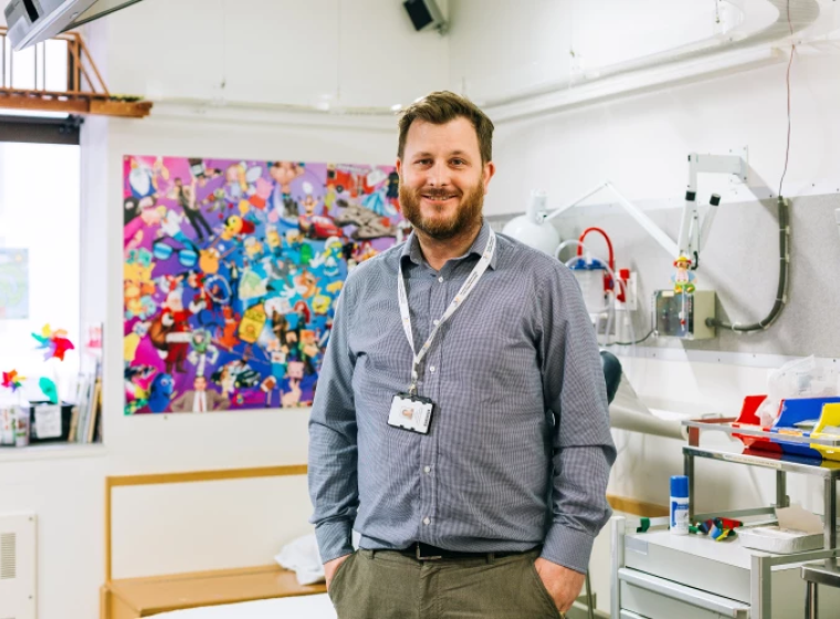 A health professional in an office smiling at the camera